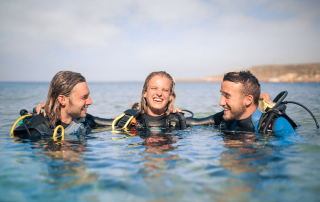 3 scuba divers (5 New Year’s Resolutions Every Scuba Diver Should Consider Making)
